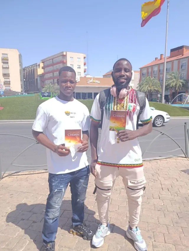 Two men holding a missionary book in Torrejón de Ardoz